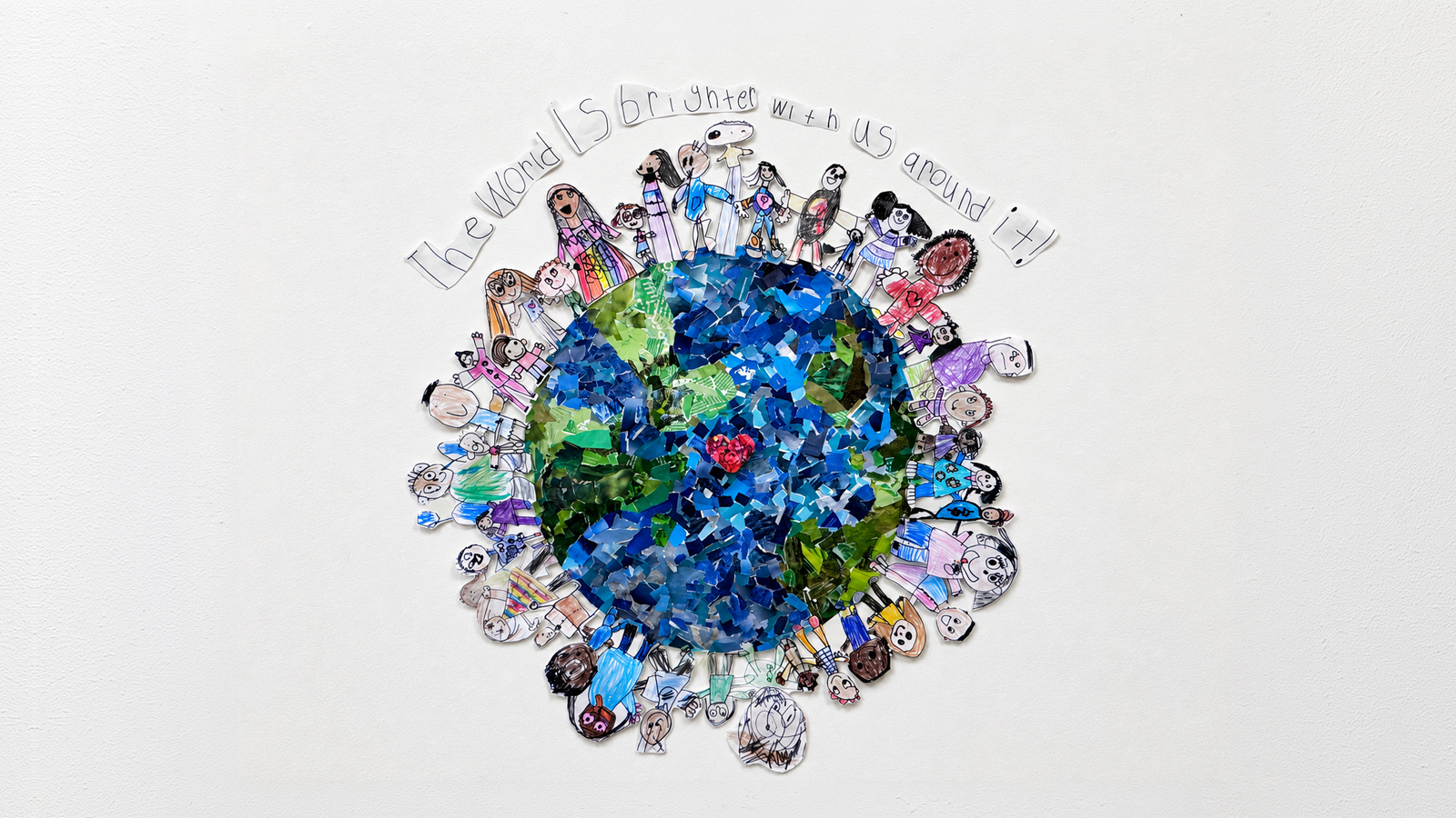 Student artwork of the Earth surrounded by children holding hands, with text reading “The world is brighter with us around it!
